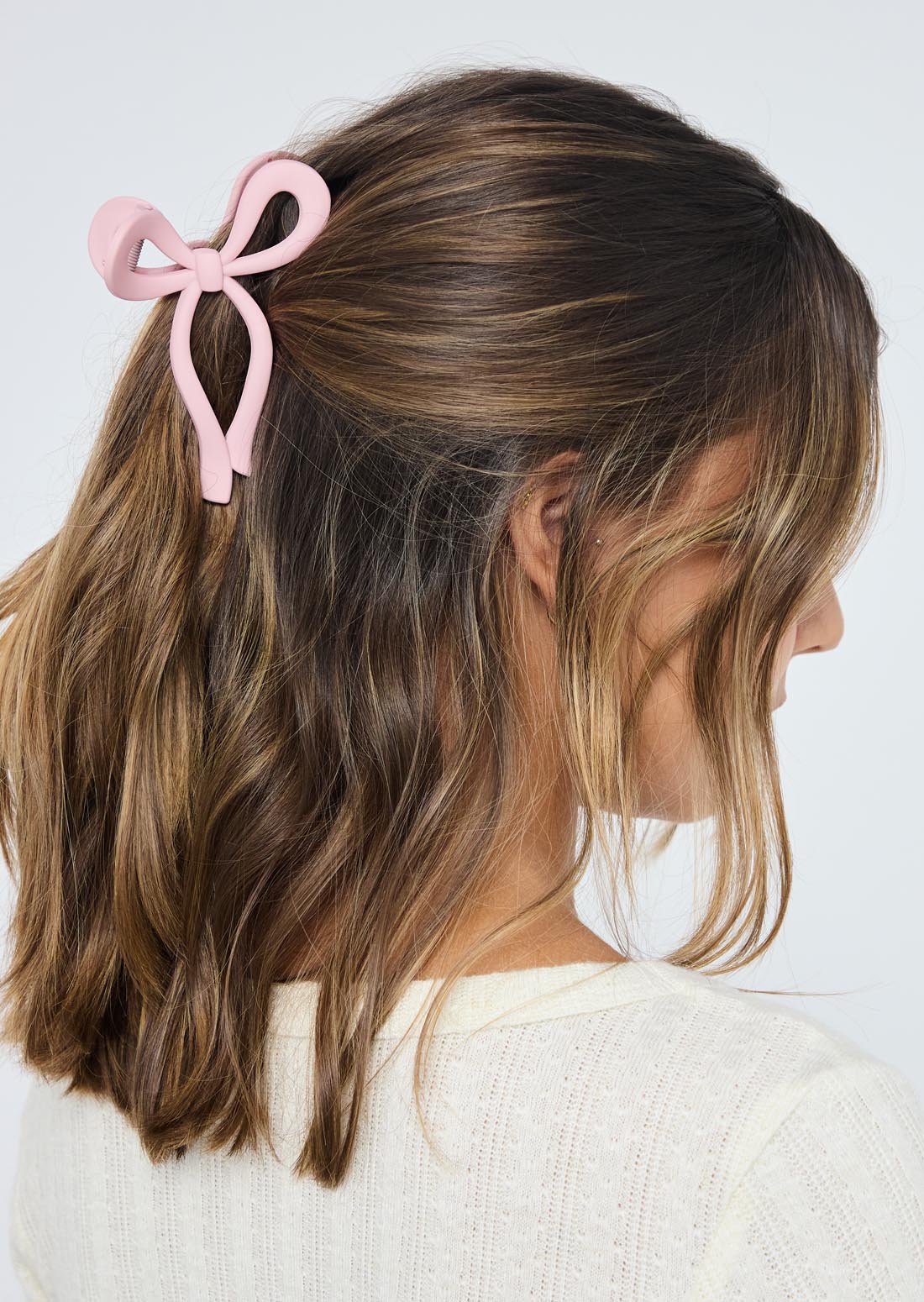 Pinza rosa en forma de moño para jóvenes